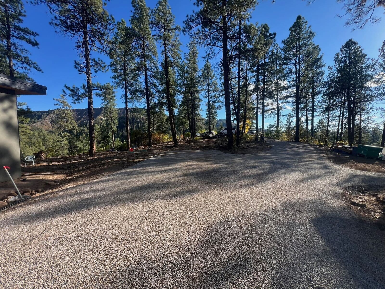 Chip and gravel parking area graded among pines in Durango, Colorado
