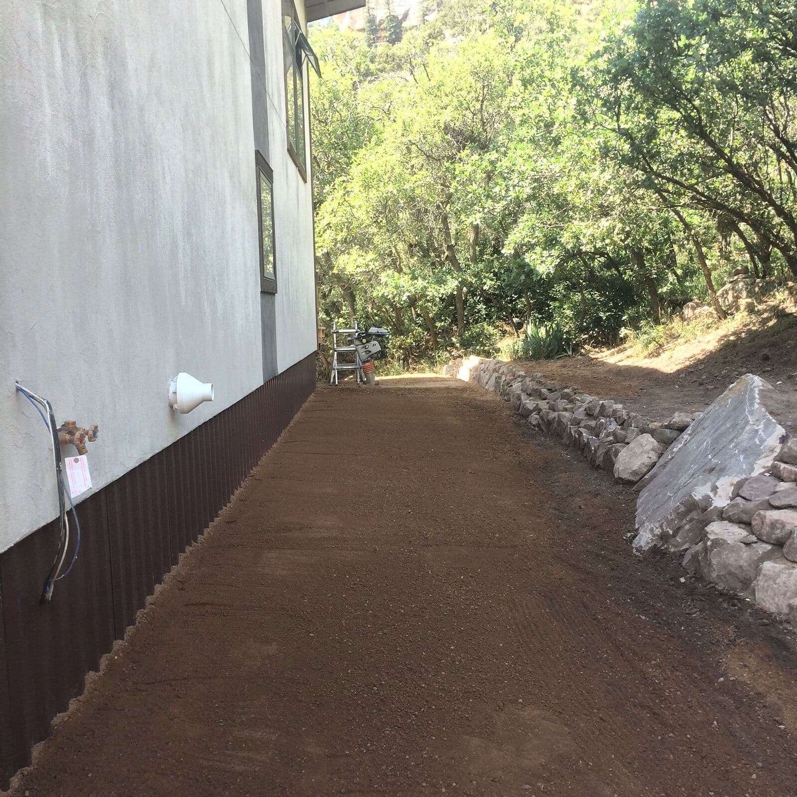 Finish grading and drainage improvement along the side of a home in Durango, Colorado
