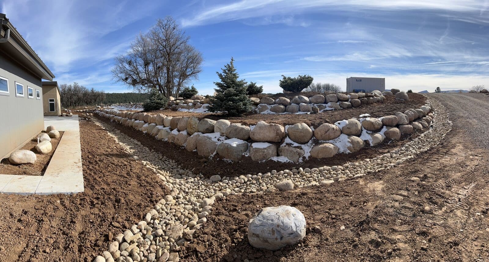 Terraced boulder walls and patio landscaping at a home near Durango, Colorado
